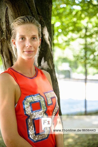 Portrait of female basketball player in park