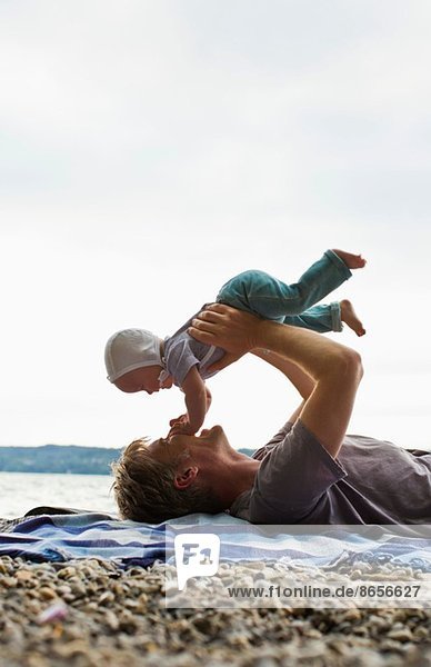 Father lifting baby daughter