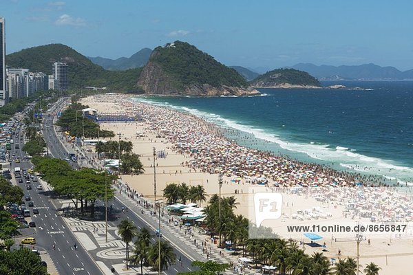 Crowds of holiday makers on Copacabana beach  Rio De Janeiro  Brazil