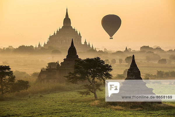 Hot air balloon over the landscape in the early morning fog  Sulamani Temple  stupas  pagodas  temple complex  Plateau of Bagan  Mandalay Division  Burma or Myanmar