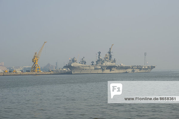 An aircraft carrier anchored in the Navy harbour  Mumbai  Maharashtra  India