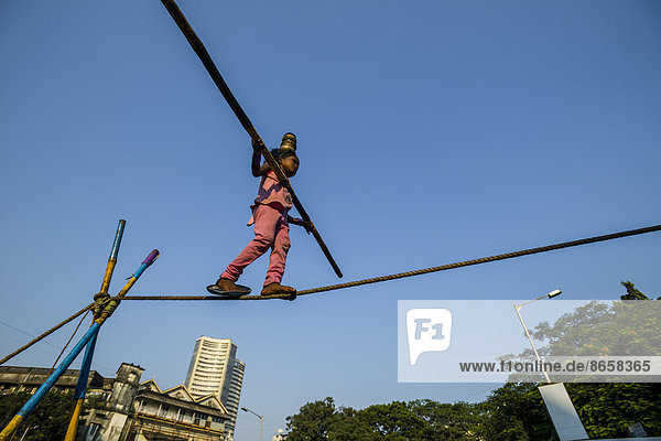A little girl is balancing on a rope  Colaba  Mumbai  Maharashtra  India