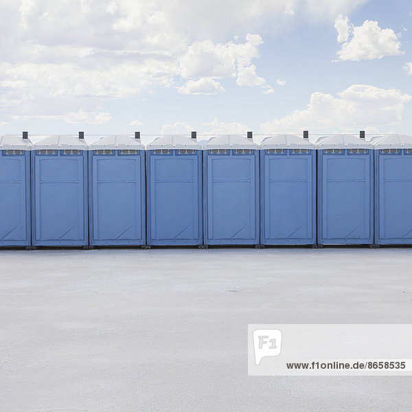 Row of portable toilets on salt flats  during Speed Week