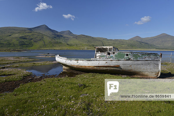 Old fishing boat  boat wreck in the bay  Munro Mountain  Argyll  Isle of Mull  Scotland  United Kingdom