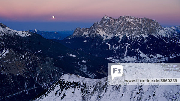 Summit of Mt Zugspitze with a full moon at dusk  Berwang  Außerfern  Tyrol  Austria