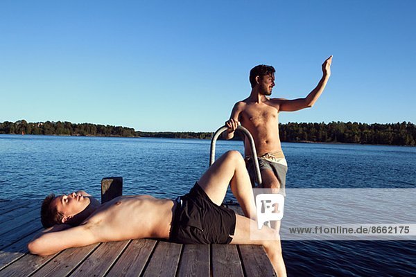 Two young men on jetty  Sweden