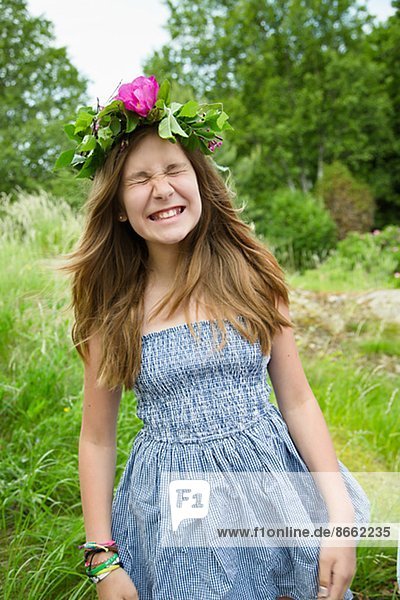 Happy girl wearing wreath of flowers  Nykoping  Sodermanland  Sweden