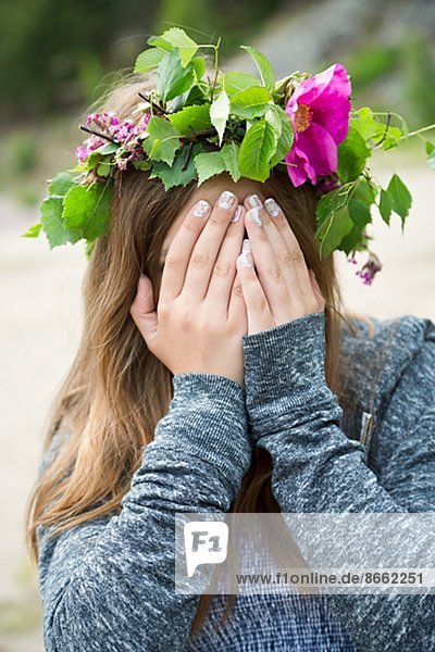 Teenage girl wearing wreath of flowers  Nykoping  Sodermanland  Sweden