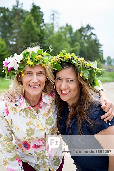 Mother and adult daughter wearing flower wreaths  Nykoping  Sodermanland  Sweden