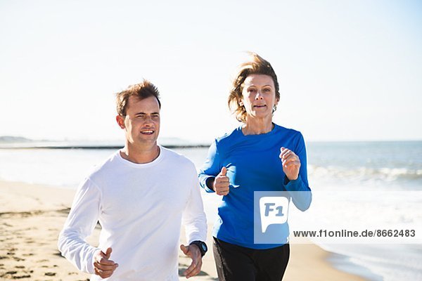 Woman and man running on beach