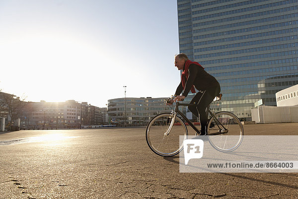 Senior man riding bicycle in Dusseldorf  Germany