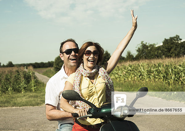 Couple riding on moped