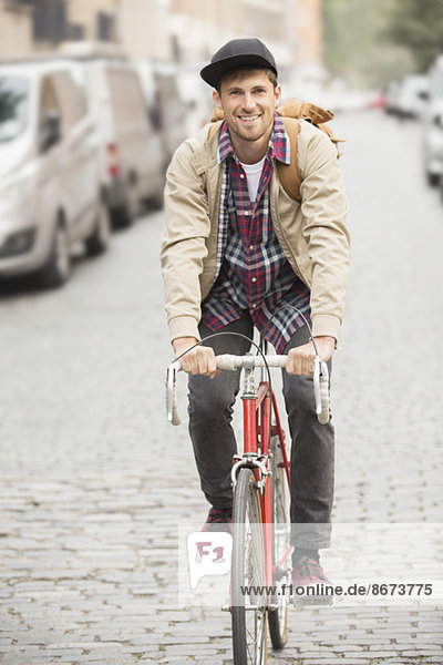 Mann fährt Fahrrad auf der Stadtstraße