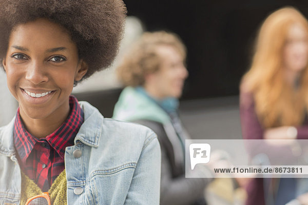 Woman smiling with friends in background