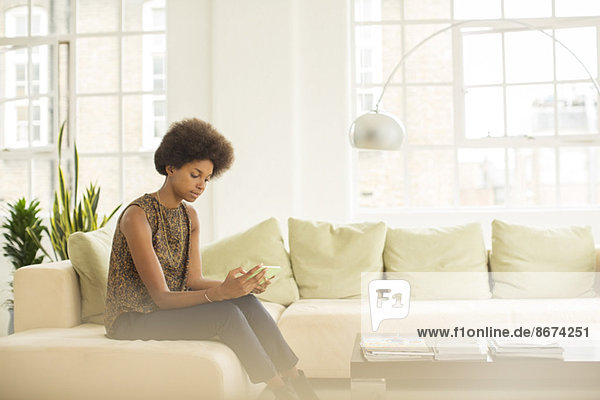 Businesswoman using digital tablet on sofa