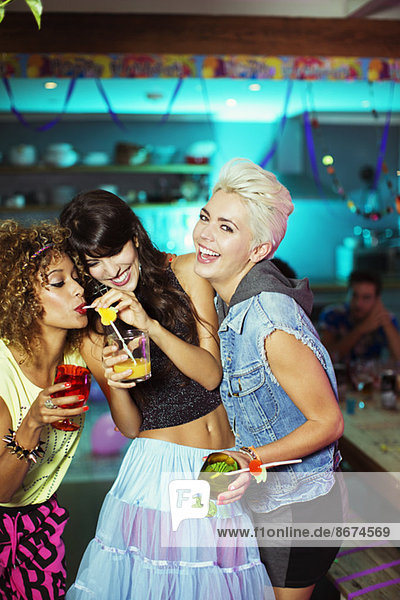Women enjoying cocktails at party