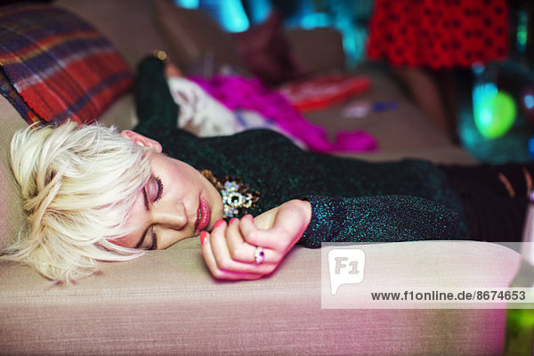 Woman sleeping on sofa at party