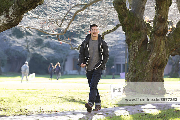 Mixed race college student walking on campus