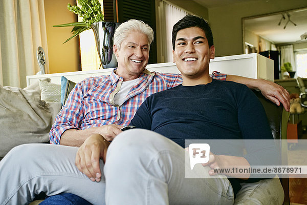 Homosexual couple relaxing on sofa