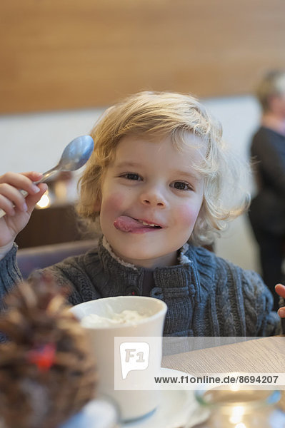 Smiling blond boy in a cafe  portrait