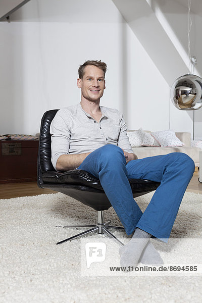 Man at home relaxing in armchair