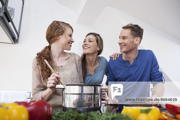 Three friends cooking together