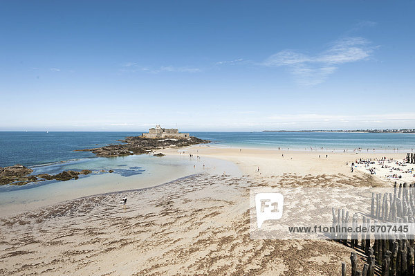 Sandy beach with groynes and Fort National  St. Malo  Brittany  France