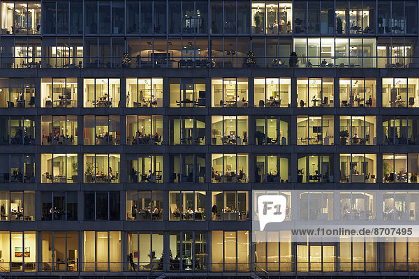 Office buildings with lighted windows  people at work  Media Harbour  Düsseldorf  North Rhine-Westphalia  Germany
