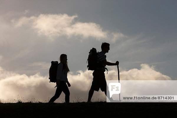 Hikers with backpack and walking stick