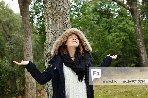 Young woman enjoying air in forest