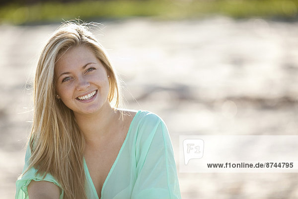 Close-up Portrait of Young Woman on Beach  Looking at Camera and Smiling  Palm Beach Gardens  Palm Beach County  Florida  USA