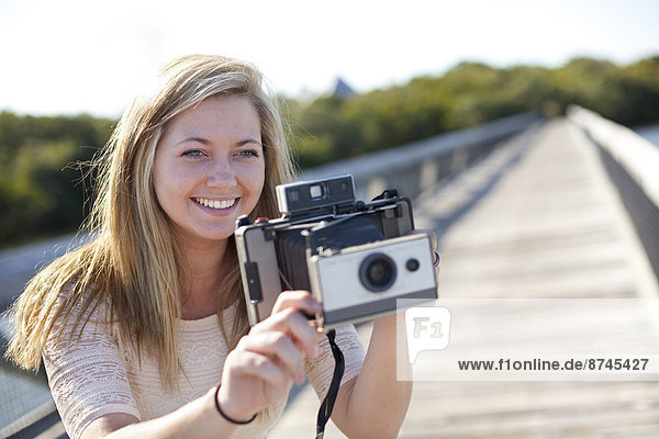Young Woman on Walkway with Camera  USA
