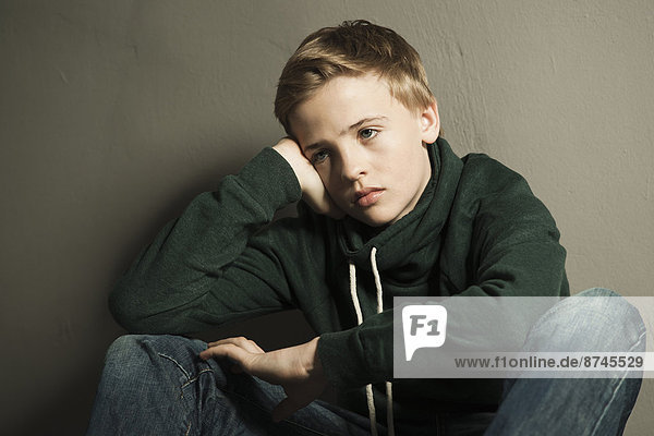 Portrait of Boy Leaning on Hand  Studio Shot