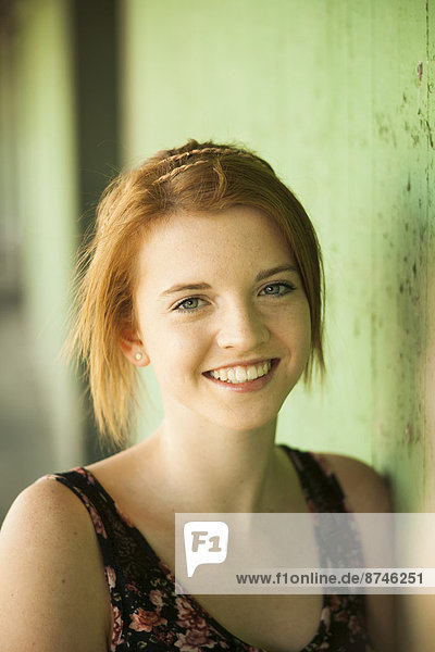 Portrait of teenage girl outdoors  smiling at camera