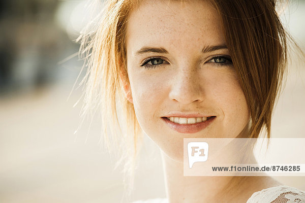 Close-up portrait of teenage girl outdoors  smiling at camera