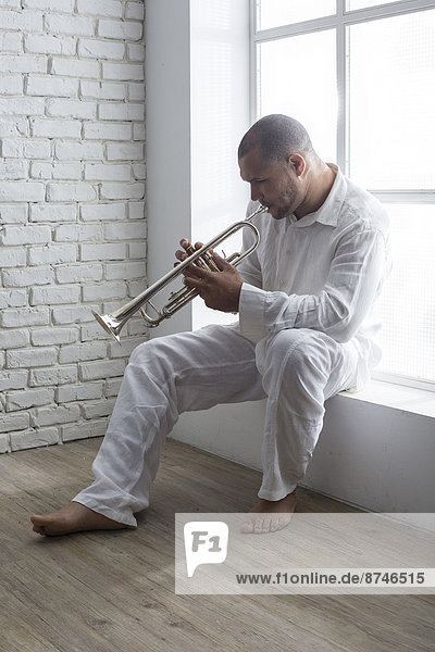 Portrait of Musician Playing Trumpet by Window  Italy