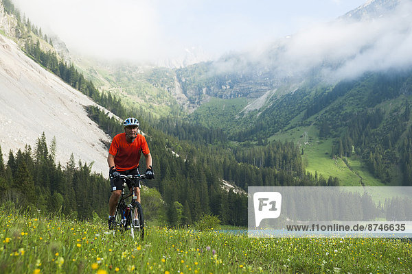 Mature Man Riding Mountain Bike by Vilsalpsee  Tannheim Valley  Tyrol  Austria