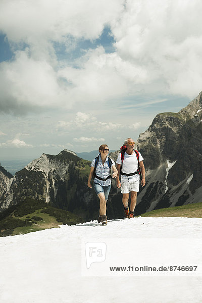 Mature couple hiking in mountains  Tannheim Valley  Austria