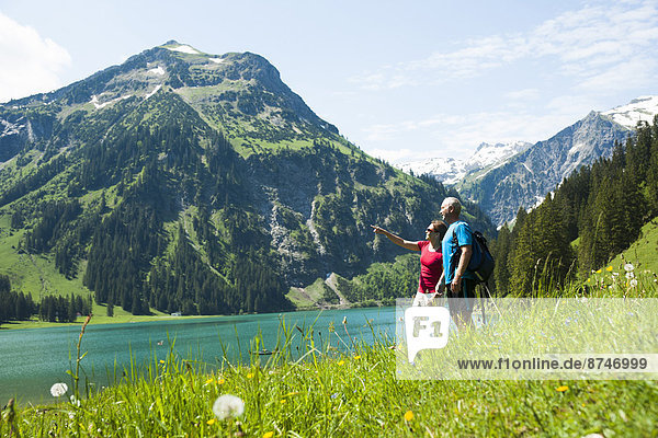 Mature man and woman looking at scenic view  Lake Vilsalpsee  Tannheim Valley  Austria