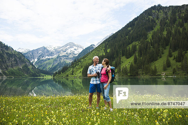 Mature couple hiking in mountains  Lake Vilsalpsee  Tannheim Valley  Austria
