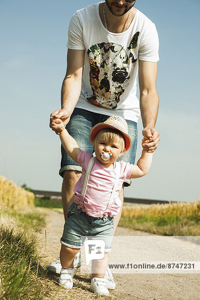 Father and Baby Daughter Walking Outdoors  Mannheim  Baden-Wurttemberg  Germany