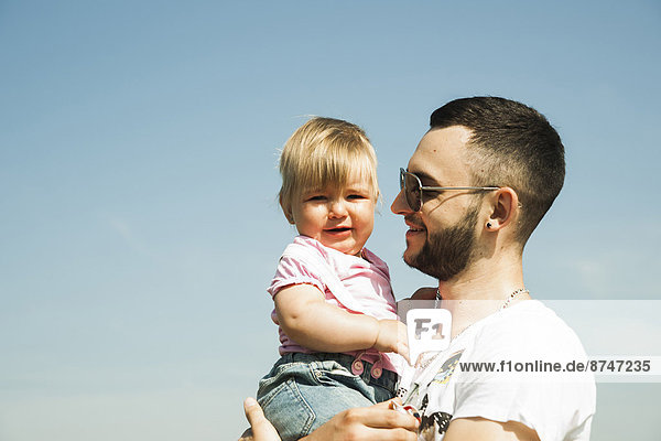 Portrait of Father Holding Baby Daughter Outdoors  Mannheim  Baden-Wurttemberg  Germany