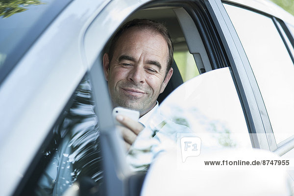 Businessman using Cell Phone while Driving  Mannheim  Baden-Wurttemberg  Germany