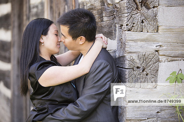 Couple Kissing by Log Cabin  Toronto  Ontario  Canada