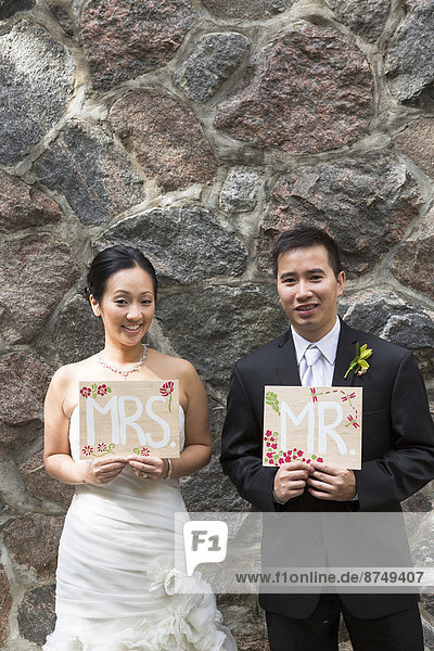 Portrait of Married Couple with Mr and Mrs Signs