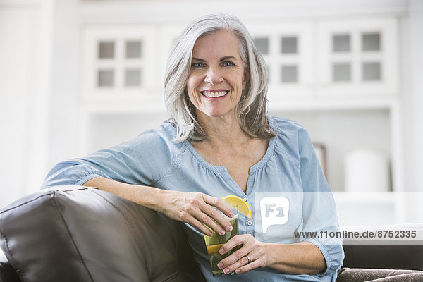 Portrait of smiling Caucasian woman drinking iced tea