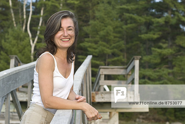 smiling woman on wooden walkway