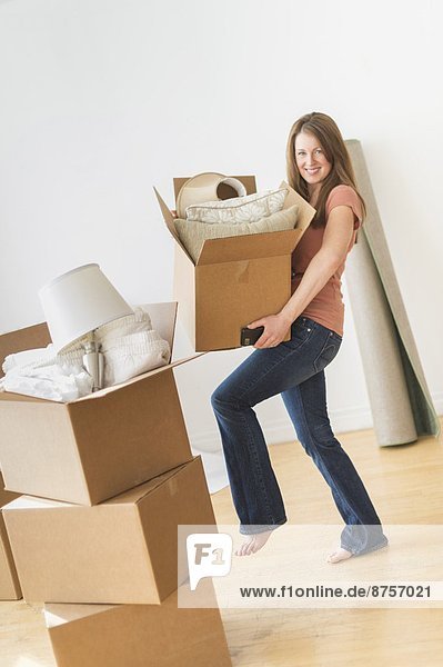Portrait of woman moving in to new house