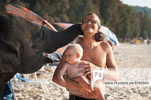 Father with baby on beach  Thailand