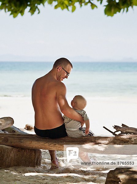 Father with baby on beach  Thailand